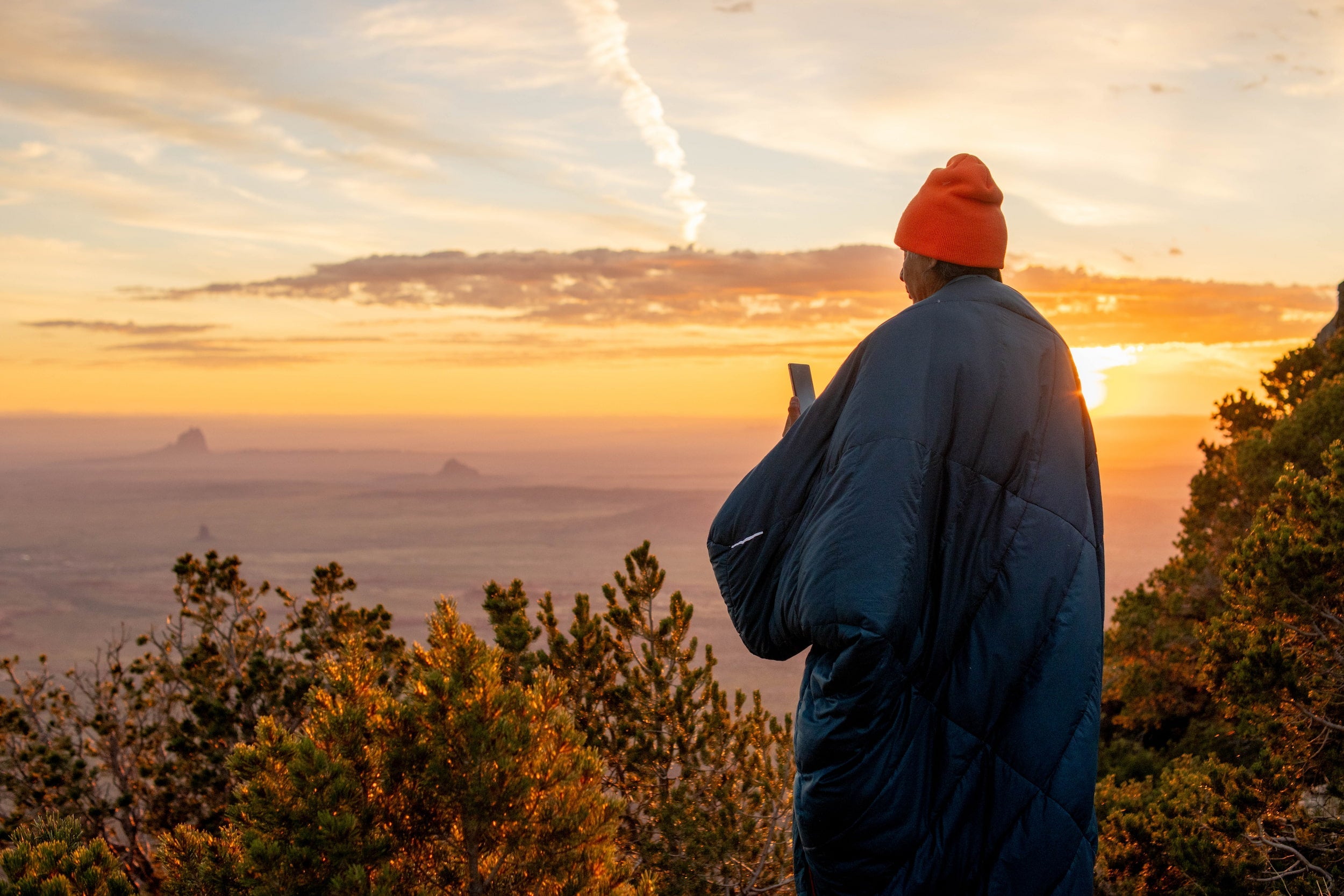 Staring into the distance wearing a sleeping bag